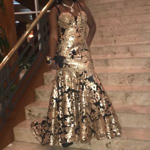 Mermaid style black and gold dress and black purse